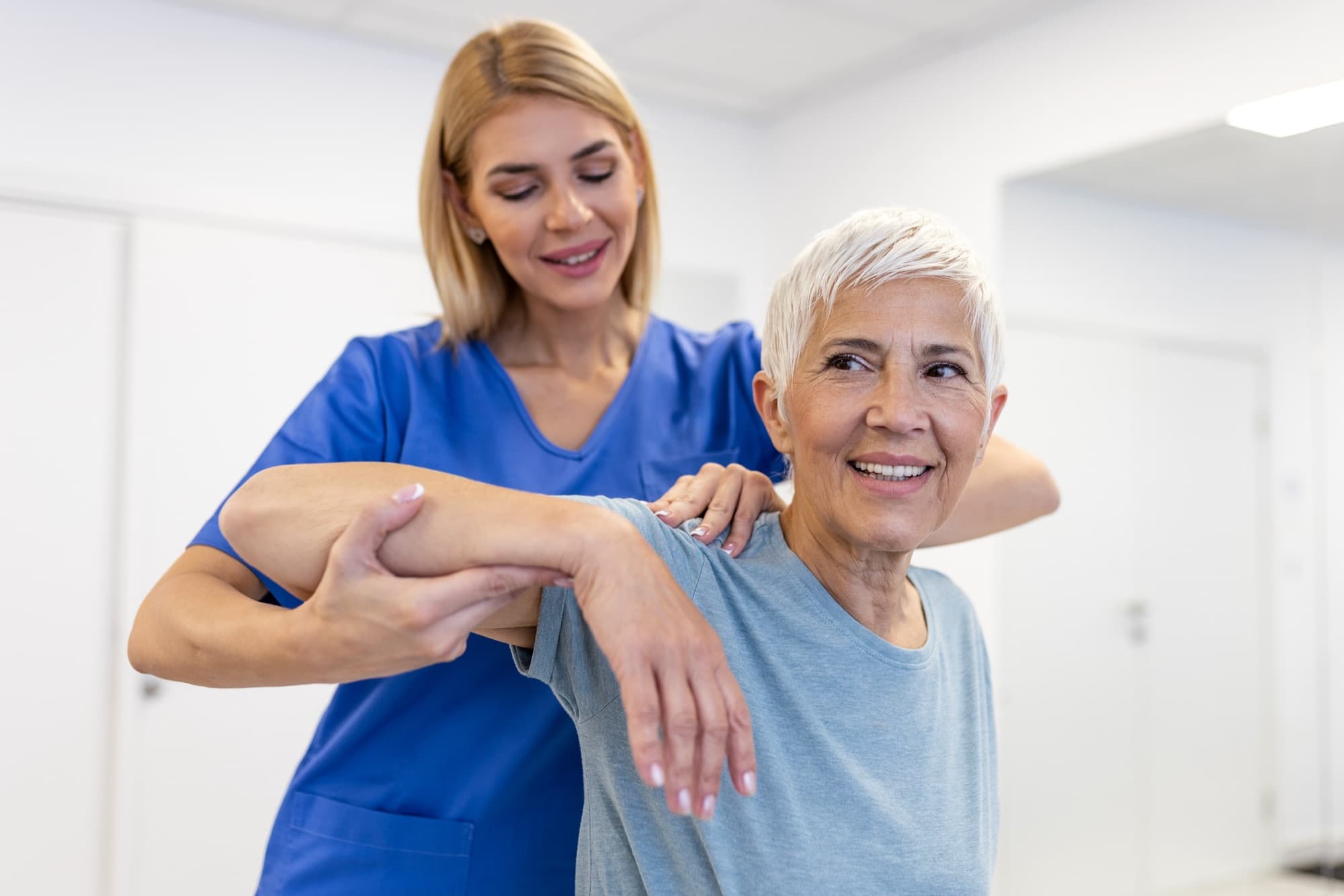 A physical therapist working one-on-one with a patient at Alliance Physical Therapy